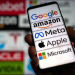 Hand holding phone displaying tech company logos