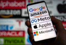 Google’s AI Search Faces First Major Legal Check Hand holding phone displaying tech company logos