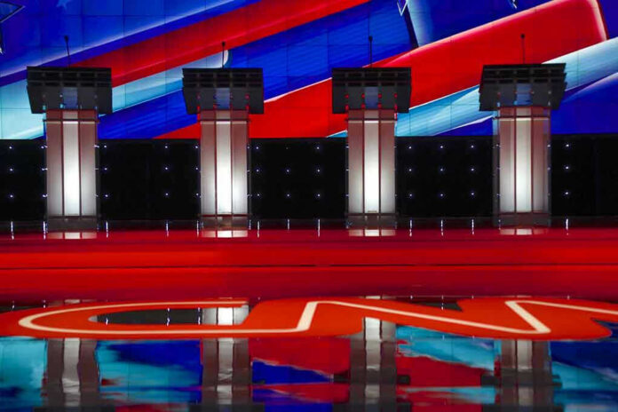 353120126-1 Four debate podiums on a CNN stage background.