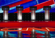 GOP Insider Sounds the Alarm on 2026 Four debate podiums on a CNN stage background.