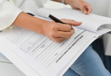 Taxpayer-Funded Losses Mount as New York Struggles Person filling out job application form.