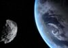 Asteroid passing near Earth in space