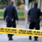 Southern California Teen Football Player Fatally Stabbed Police officers walking past caution tape at a crime scene