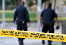 Florida Sergeant Accused of Battering Elderly Couple Police officers walking past caution tape at a crime scene