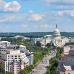 United States Capitol building with city street and skyline