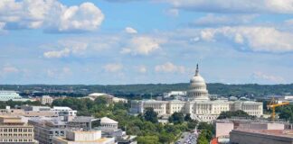 United States Capitol building with city street and skyline