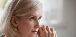 Woman with short blonde hair in thoughtful pose