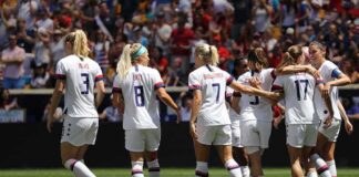 women's soccer team celebrating on the field
