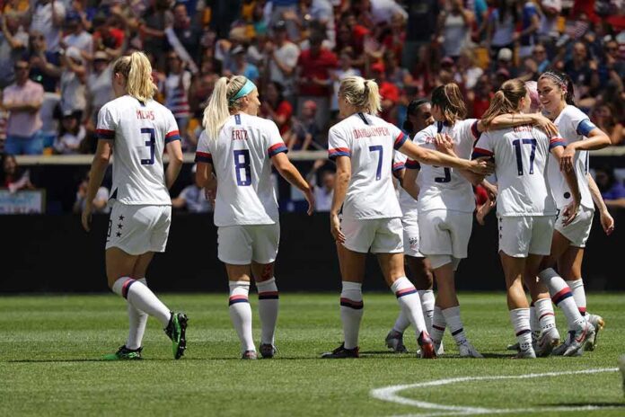 women's soccer team celebrating on the field