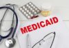 Minnesota Medicaid Fraud Probe Grows Medicaid document with stethoscope and medications on desk