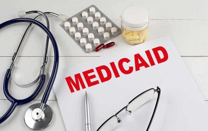 shutterstock_2201257403 Medicaid document with stethoscope and medications on desk