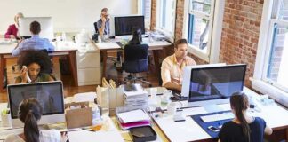 Open plan office with people working at desks