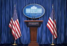 Russia Raises Nuclear Stakes With New Warning White House press podium with microphones and two American flags