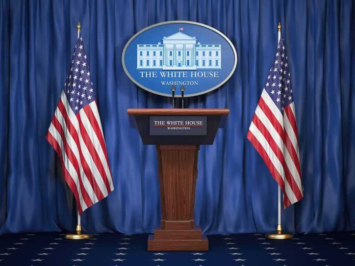 shutterstock_1159933525-1 White House press podium with microphones and two American flags