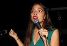Woman speaking into a microphone on stage