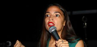 Woman speaking into a microphone on stage
