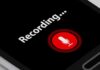 smartphone screen showing a red microphone recording button