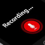 smartphone screen showing a red microphone recording button
