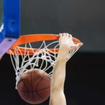 WNBA Meltdown: Lifetime Bans Over Throws Basketball player dunks ball through orange rim