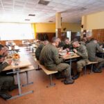 soldiers eating together in a cafeteria