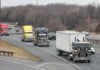 Convoy of semi trucks driving on a multi-lane highway