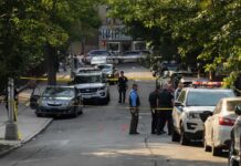 A Deadly Workplace Prank Now Has Criminal Consequences Police officers secure a residential street with patrol cars and yellow tape