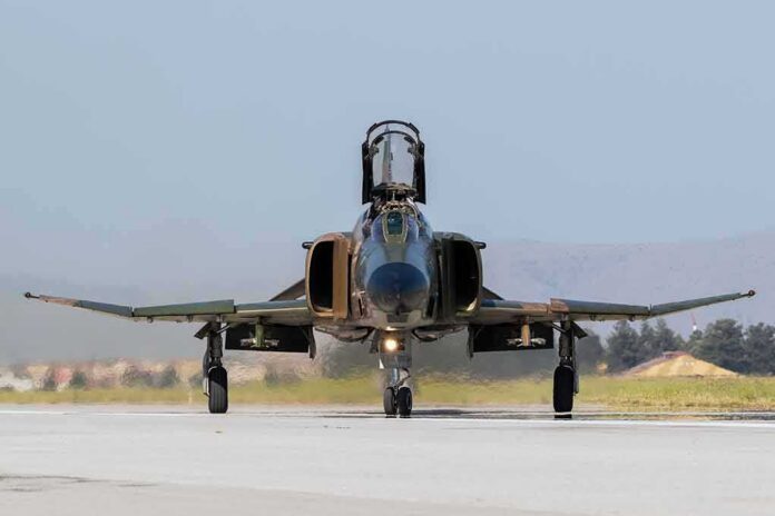 shutterstock_673984819 Military jet taxiing on runway with open canopy