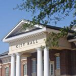 America’s Political Debate Is Shifting From Facts to Personal Attacks Exterior view of a city hall building with columns and a clear blue sky