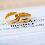 Gold wedding rings on a divorce document