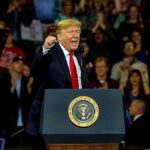 Trump Vows More Strikes on Iran man speaking at a podium during a rally