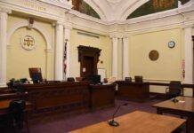 Gala Chaos: Nonprofit Boss Accused Of Stiffing empty courtroom with judge's bench and columns