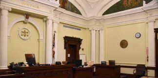empty courtroom with judge's bench and columns