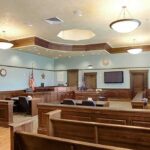 Huawei Trial Puts Tech Theft Claims on Trial Empty courtroom with wooden benches and judge's bench