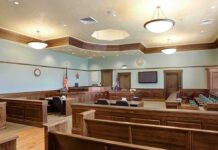 Huawei Trial Puts Tech Theft Claims on Trial Empty courtroom with wooden benches and judge's bench