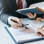 Marriage Names: U.S. Law Protects Freedom of Choice Hands signing a legal document at a desk
