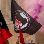 Thousands Protest as AfD Holds National Convention protesters with antifascist flags and purple smoke