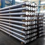 Pentagon’s New Weapons Are 12 Years Late Stacked metal rods on pallets in an industrial warehouse