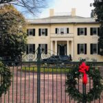 Police: No Targeted Threat After Driver Crashes Through Security Gate Holiday wreaths on iron gate before a grand mansion