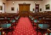 Firehouse Horror: Former NJ Officer Faces Charges Courtroom with wooden benches facing the judge's bench