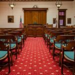 Firehouse Horror: Former NJ Officer Faces Charges Courtroom with wooden benches facing the judge's bench