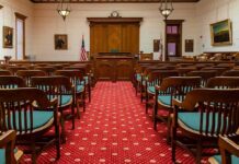 Firehouse Horror: Former NJ Officer Faces Charges Courtroom with wooden benches facing the judge's bench
