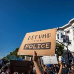 After Fatal Police Shooting, Madison Faces a Battle protesters holding signs at a street demonstration