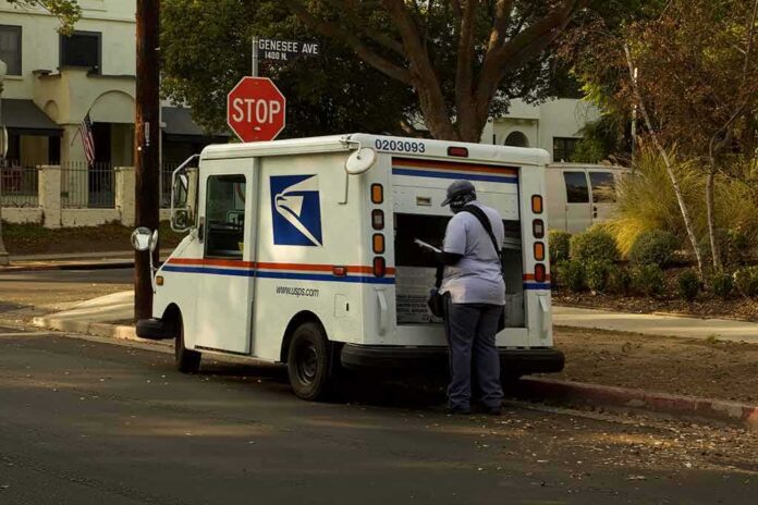 Mail carrier standing behind a USPS truck on a suburban street