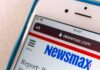 Smartphone displaying Newsmax website