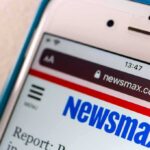 Smartphone displaying Newsmax website