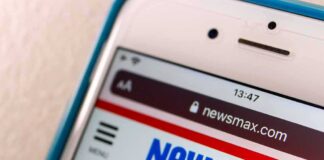 Smartphone displaying Newsmax website