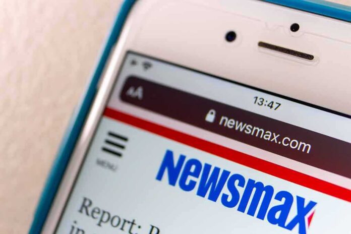shutterstock_1934425964 Smartphone displaying Newsmax website