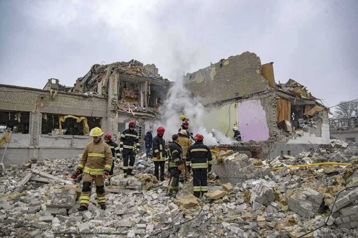 shutterstock_2132623665 Firefighters search rubble of a partially collapsed building