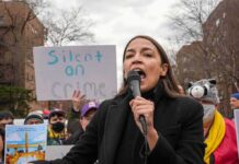 AOC’s Role Becomes Democratic Campaign Issue woman speaking into a microphone at an outdoor protest