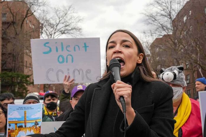shutterstock_2139769939 woman speaking into a microphone at an outdoor protest
